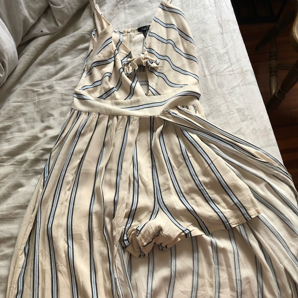 A romper with a cape attached at the waist